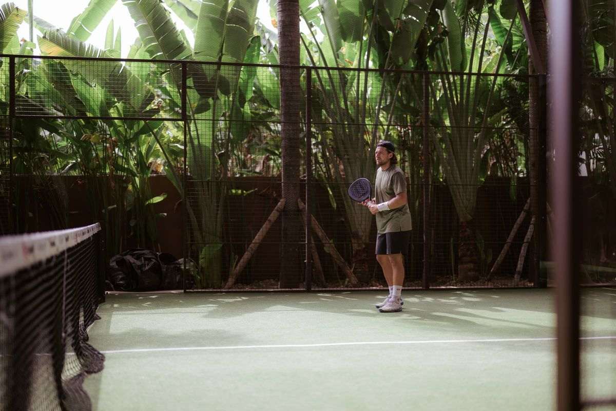 Padel coach preparing to play on court
